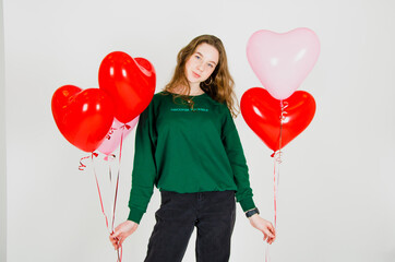 girl holding balloons on a white background. concept of birthday celebration, valentine's day, women's day