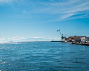 Thessaloniki Greece January 30, 2021: the entrance of the old port and the blue sea with a blue sky is magical and the road that people can enjoy their walk