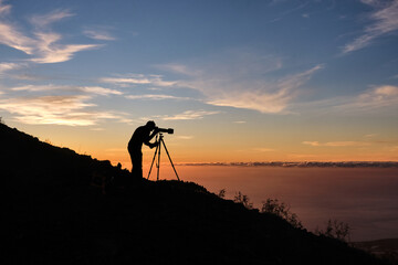 silhouette of a photographer in a sunset in El Paso, La Palma Island, Spain. in February 2020