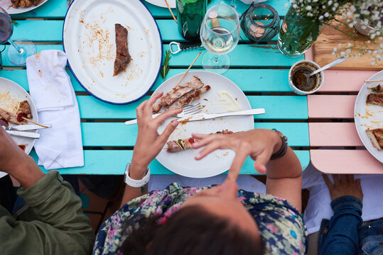 Close-up of unrecognizable person eating delicious food at dinner .From above
