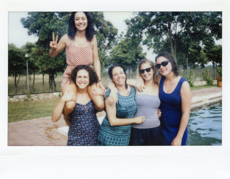 Cheerful friends showing peace signs at camera
