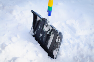 A huge snowdrift and a snow shovel.