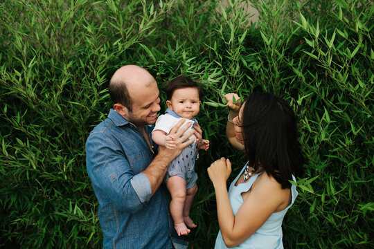 Mother and father fuss over their adorable child.