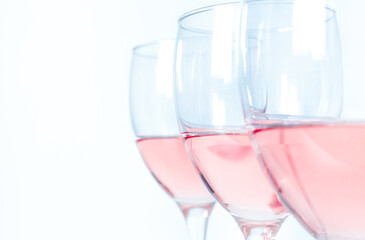 close-up three glasses with rose wine on a white background