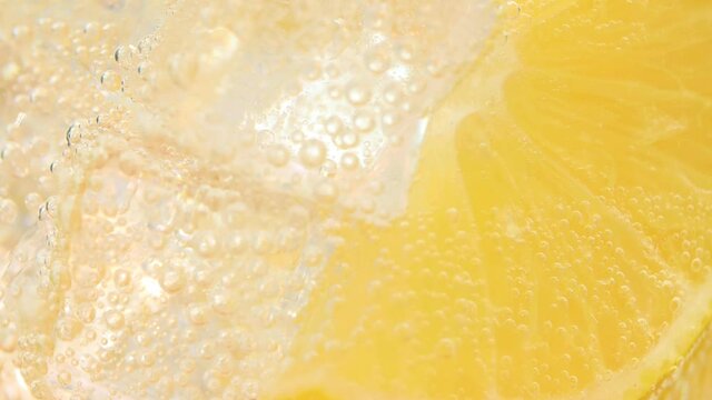 Refreshing soft cold lemonade mojito drink with slices of lemon and sparkling water. 4k resolution, macro shot. High quality 4k footage