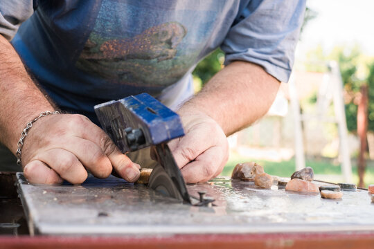 Close up of a Man Cutting Stones
