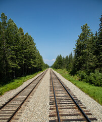 Railway tracks heading towards a mountain