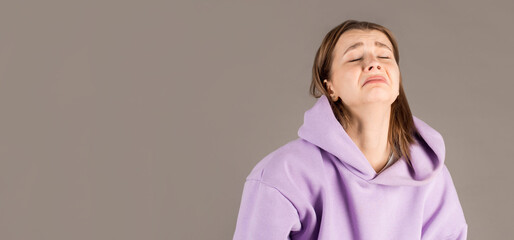 Portrait of desperate girl in sweater feeling sorry for mistake. indoor studio shot isolated on...