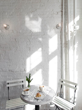 White table with coffee and crossaint