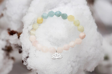 Mineral stone bracelet on snow background