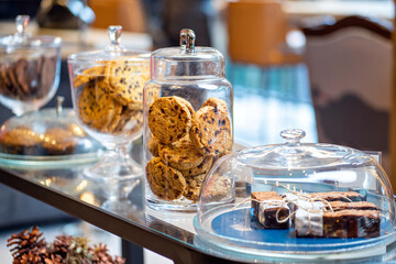 Fototapeta na wymiar Assortment of fresh home made cookies and cakes in glass jar bakery shop