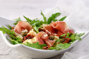  Arugula salad, prosciutto with sun-dried tomatoes, slices of mozzarella, capers, seasoned with olive butter and parmesan. A dish for those who monitor their health