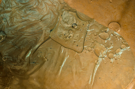 Closeup of patterns created by the intermixing of water, oil and paint