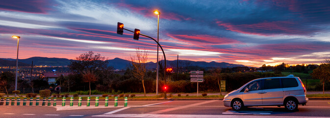 Road with traffic lights and cars at dusk