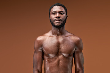 Fototapeta na wymiar afro sportsman posing after active intense training, he is looking at camera, sweaty and exhausted