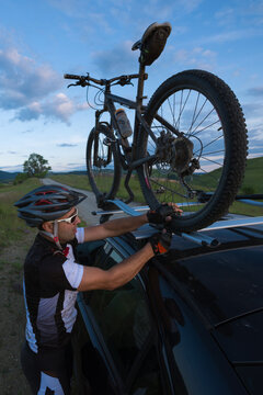 Mountain Bike Rider Fitting His Bike In A Car Rack