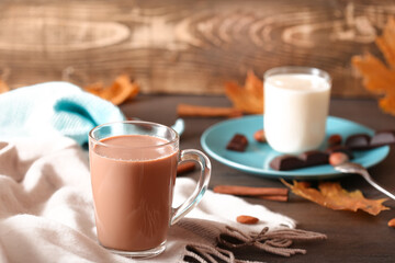 Cup of cocoa with straw on a dark wooden background
