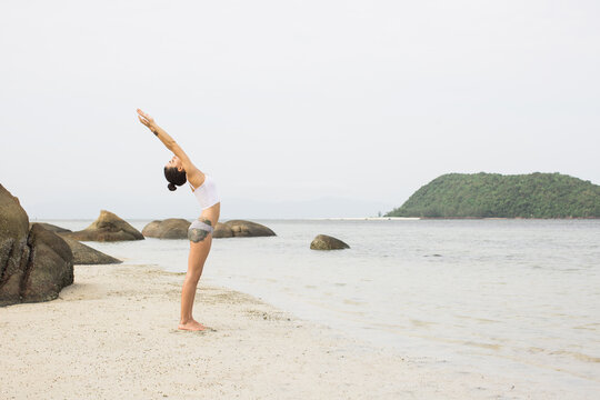Woman Doing Yoga at the Beach