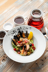 Luxury muscled salad on light wooden table, beautiful magazine shot