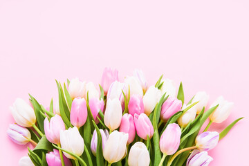 Pink and white tulips bouquet on a light pink background, selective focus. Flat lay, copy space