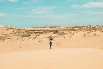 person running on the dunes