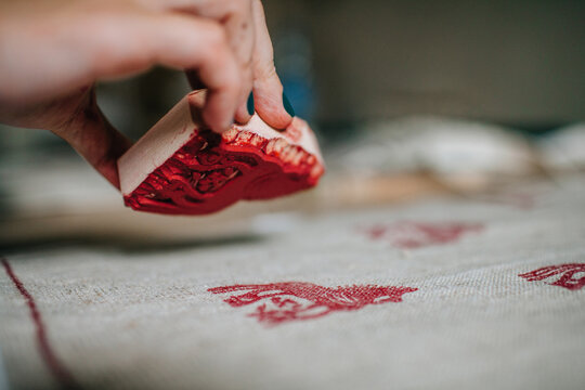 Crop hand holding wooden stamping template