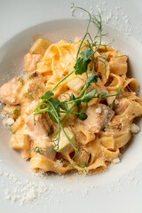 Avocado and salmon fettuccine, appetizing magazine photo
