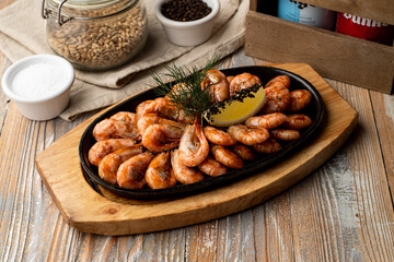 Whole big portion of king shrimps as a snack to beer on a tray, top view