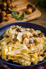 Tagliatelle pasta with forest mushrooms and chicken.