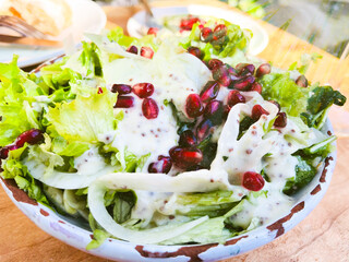  Close up healthy salad of fresh vegetables and pomegranate seeds.
