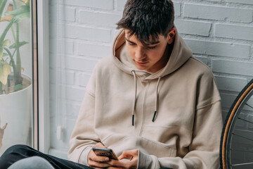young person or teenager at home with mobile phone