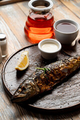 Rustic-style roasted fish with head, wooden plate, soft light, food magazine photo