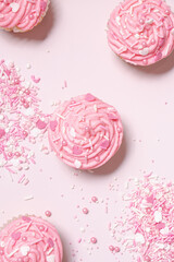 homemade vanilla cupcakes with pink buttercream frosting and heart sprinkles 