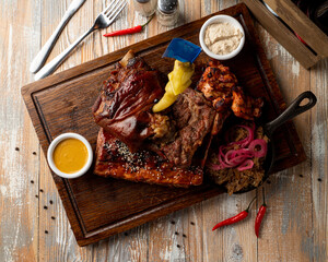 Typical german beer restaurant meals: baked ribs with pickled snacks around