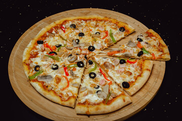 Delicious fresh pizza served on wooden plate. Pizza with olives.
