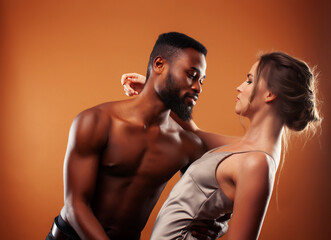 Fototapeta na wymiar Young pretty couple diverse races together posing sensitive on brown background, lifestyle people concept
