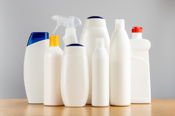 Hair and body cleansers and bathroom and window cleaners. Household chemicals on a gray background.