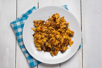 Scrambled eggs with chorizo for breakfast on white background. Mexican  food