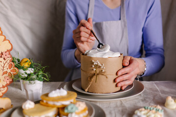The process of decorating an Easter cake with culinary sprinkles and marshmallows. Cupcake close-up...