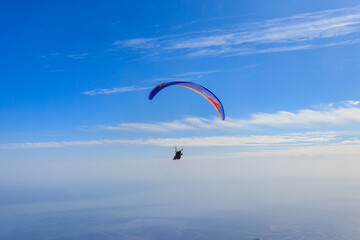 Paragliders in blue sky. Concept of active lifestyle and extreme sport adventure