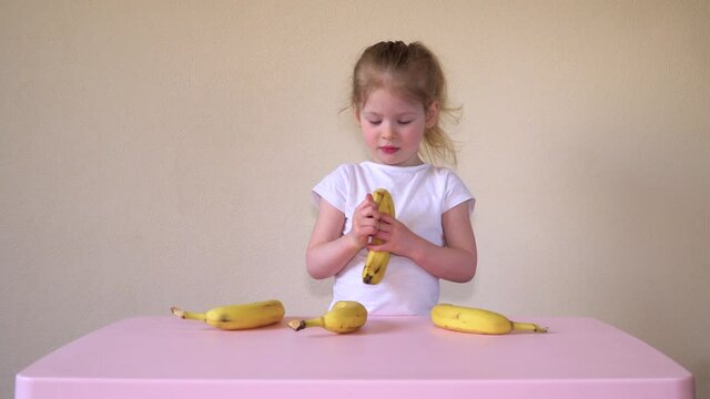 Banana. Caucasian girl eating. Children's food. Healthy food. High quality 4k footage