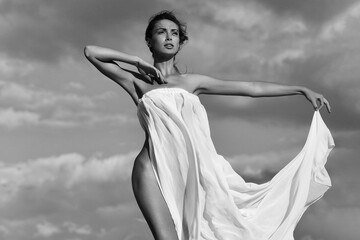 Feminine. Young sensual woman with slim body in white sexy dress nude. Beautiful boho style girl.