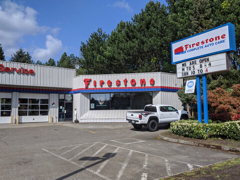 Woodinville, WA / USA - circa April 2020: Street view of a Firestone Complete Auto Care Center on a sunny day.