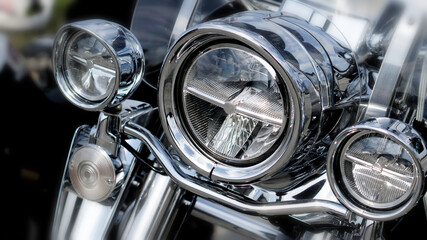 Shiny chrome motorcycle headlights. Close-up