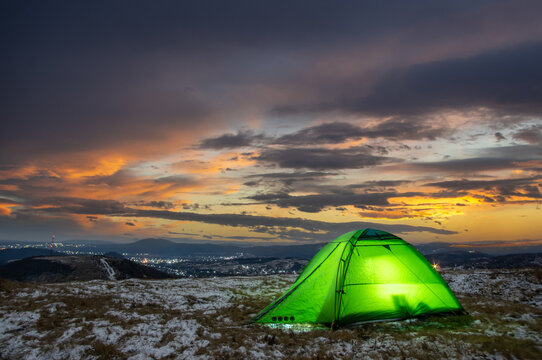 Tent on top of a mountain against the backdrop of a sunset in the Carpathians