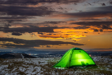 Fototapeta na wymiar Tent on top of a mountain against the backdrop of a sunset in the Carpathians