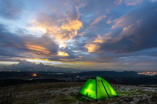 Tent on top of a mountain against the backdrop of a sunset in the Carpathians