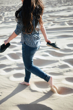 Barefoot woman running on the sand