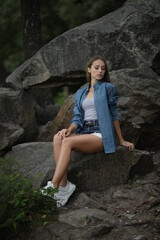 woman sitting on stones