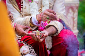 Fototapeta na wymiar Indian Hindu couple's hands close up, wedding ceremony, religious items and rituals, pooja